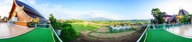 NAN, THAILAND - November 4, 2020 : Panorama View of Thai Style Building and Rice Fied at Si Mongkol Temple, Nan Province.