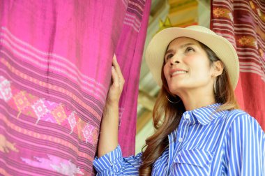 Thai Girl in Blue Dress with Thai Cloth Background, Nan Province.
