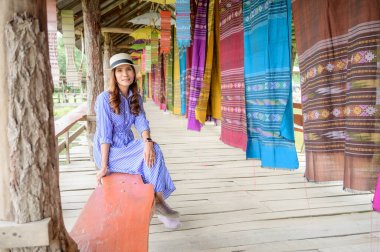 Thai Girl in Blue Dress with Thai Cloth Background, Nan Province.