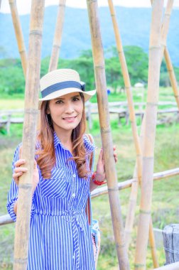 Thai Girl in Blue Dress with Park Background, Nan Province.