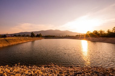 Reservoir with mountain view at sunset, Chiang Mai province.