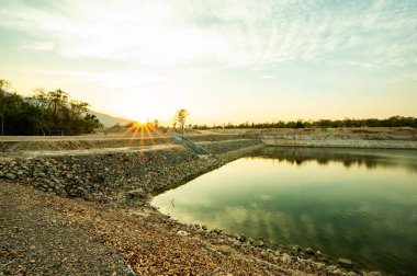 Reservoir with walkway at sunset, Chiang Mai province.