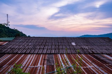 Roof with evening sky at Doi Pui Mong hill tribe village, Chiang Mai province.