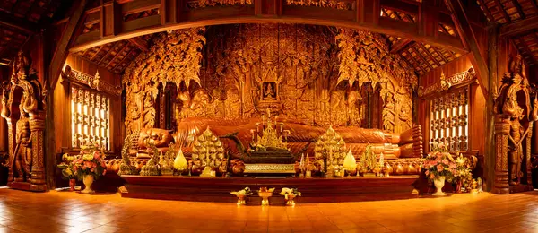 Panorama Image of Reclining Buddha and Beautiful Wooden Building at Wat Luang Khun Win, Chiangmai Province.