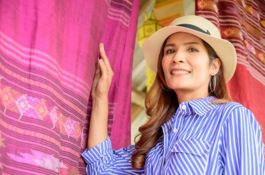 Thai Girl in Blue Dress with Thai Cloth Background, Nan Province.