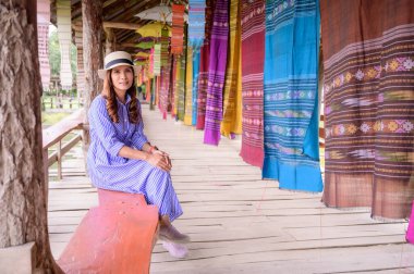 Thai Girl in Blue Dress with Thai Cloth Background, Nan Province.