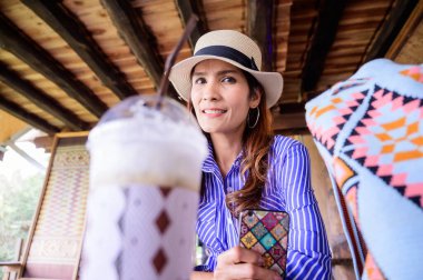 Thai Girl in Blue Dress at Coffee Shop, Nan Province.