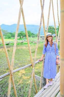 Thai Girl in Blue Dress with Park Background, Nan Province.