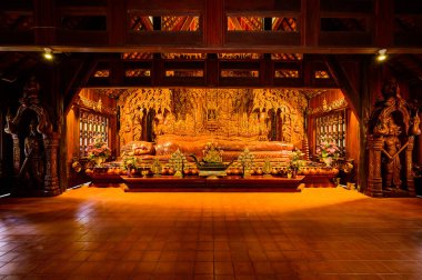 The Wooden Reclining Buddha of Wat Luang Khun Win in Chiangmai Province, Thailand.