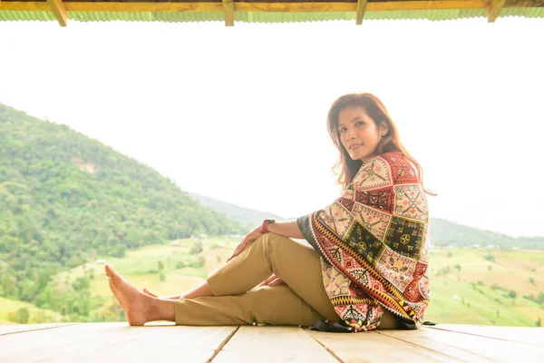 Asian Woman in Thai Native Pavilion with Rice Field Background at Pa Bong Piang Rice Terraces, Chiangmai Province.