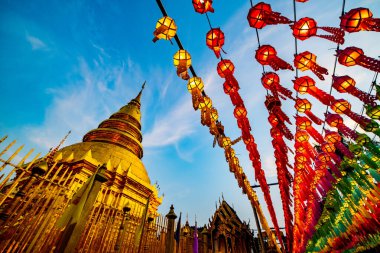 Lanna style lantern with ancient pagoda in Phra That Hariphunchai temple, Lamphun province.