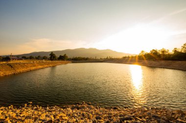 Reservoir with mountain view at sunset, Chiang Mai province.