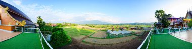 NAN, THAILAND - November 4, 2020 : Panorama View of Thai Style Building and Rice Fied at Si Mongkol Temple, Nan Province.