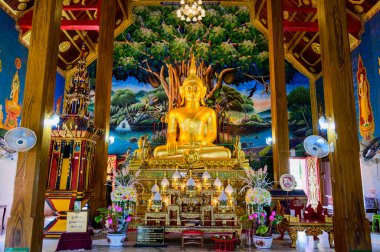NAN, THAILAND - November 5, 2020 : Old Buddha Statue with Thai Style Church in Prang Temple, Nan Province.