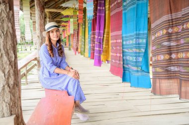 Thai Girl in Blue Dress with Thai Cloth Background, Nan Province.