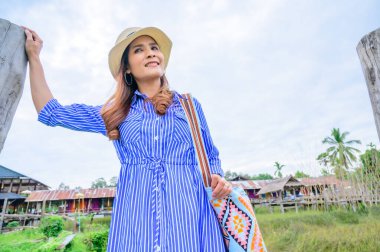 Thai Girl in Blue Dress with Park Background, Nan Province.