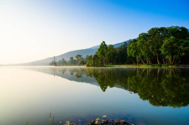 Huay Tueng Thao Lake in the early morning, the lake offers beautiful scenery, fresh air and steam rising from the surface, Chiang Mai Province.