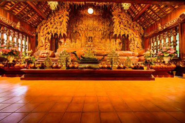 The Wooden Reclining Buddha of Wat Luang Khun Win in Chiangmai Province, Thailand.