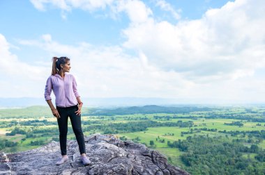 Thai Woman with Pha Hua Reua Background in Phayao Province, Thailand.
