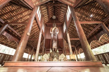CHIANG MAI, THAILAND - March 19, 2022 : The Wooden Standing Buddha of Wat Luang Khun Win in Chiangmai Province, Thailand.