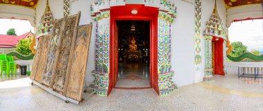 NAN, THAILAND - November 5, 2020 :  Panorama View of Old Buddha Statue with Thai Style Church in Prang Temple, Nan Province.