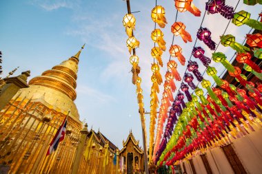 Lanna style lantern with ancient pagoda in Phra That Hariphunchai temple, Lamphun province.