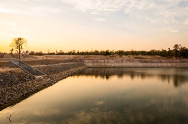 Reservoir with walkway at sunset, Chiang Mai province.