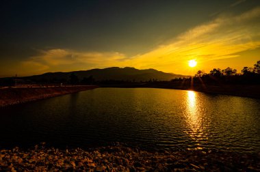 Reservoir with mountain view at sunset, Chiang Mai province.
