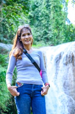 Phayao 'daki Doi Phu Nang Milli Parkı' nda Than Sawan Şelalesi ile birlikte Asya Kadını.