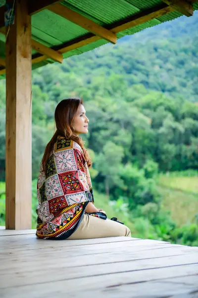 Asian Woman in Thai Native Pavilion with Rice Field Background at Pa Bong Piang Rice Terraces, Chiangmai Province.