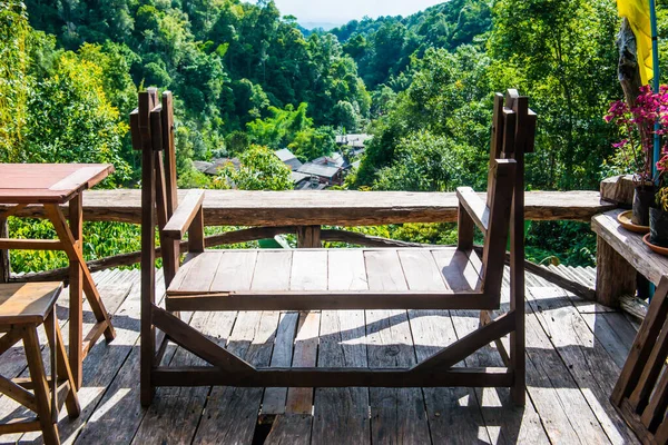 Wooden table set at view point in the forest, Thailand.
