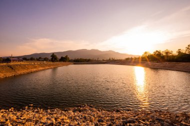 Reservoir with mountain view at sunset, Chiang Mai province.