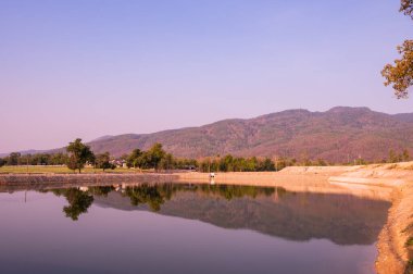 Reservoir with mountain view at evening, Chiang Mai province.