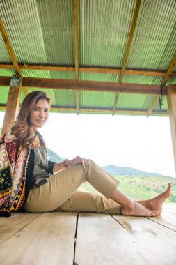 Asian Woman in Thai Native Pavilion with Rice Field Background at Pa Bong Piang Rice Terraces, Chiangmai Province.