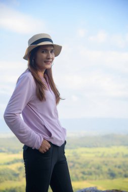 Thai Woman at Pha Hua Reua Viewpoint in Phayao Province, Thailand.