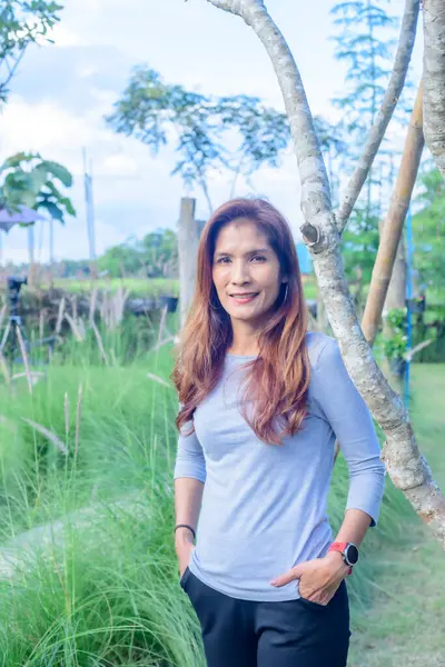 Asian Woman in Park at Phayao Province, Thailand.