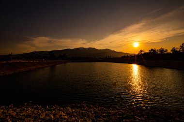 Reservoir with mountain view at sunset, Chiang Mai province.
