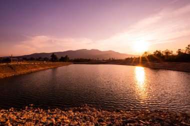 Reservoir with mountain view at sunset, Chiang Mai province.