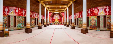 PHAYAO, THAILAND - July 19, 2020 : Beautiful golden Buddha statue with Thai style church of Si Khom Kham Temple, Phayao province.