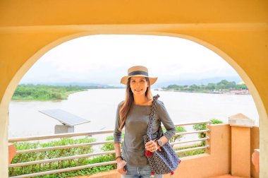 Asia Woman Traveler with Golden Triangle Background, Chiang Rai Province.