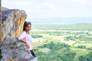 Thai Woman with Pha Hua Reua Background in Phayao Province, Thailand.