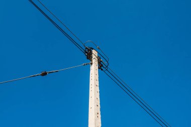 Electrical pole with wire on blue sky, Thailand