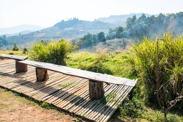 Wooden chairs on mountain, Thailand.