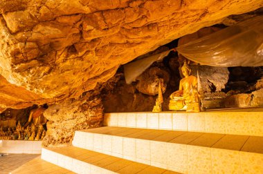 Phra Sabai cave with golden Buddha in Lampang province, Thailand.