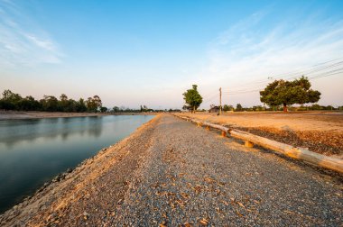 Reservoir with walkway at sunset, Chiang Mai province.