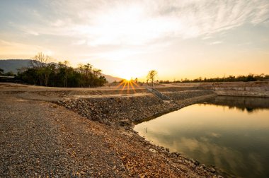 Reservoir with walkway at sunset, Chiang Mai province.
