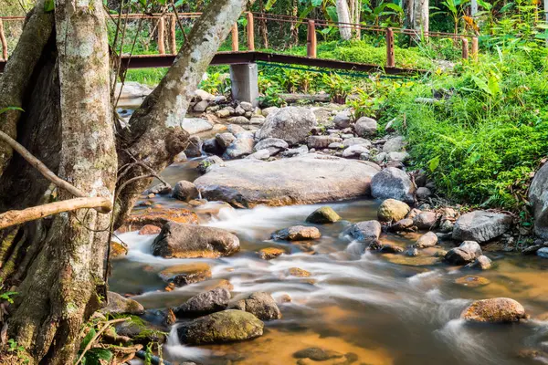 Beautiful water flowing with bridge in nature, Thailand