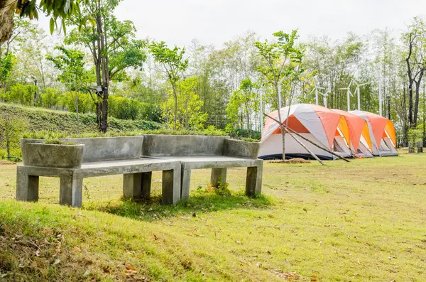 Concrete bench with camping tents, Thailand