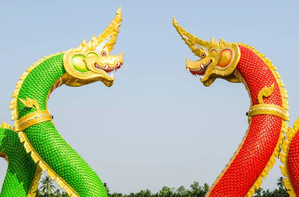 Mavi gökyüzünde yeşil ve kırmızı Naga heykeli, Tayland
