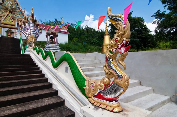 Naga statue on stair hand rail at Wat Kaolam temple, Thailand.